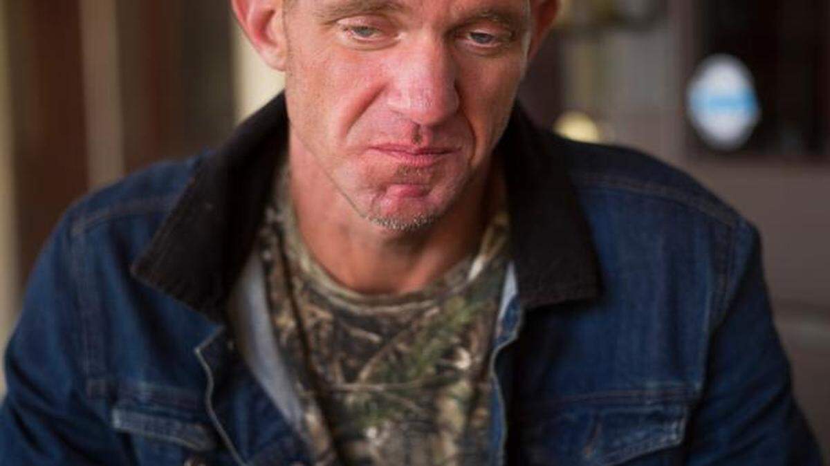 
Ryan Hoffman tears up while talking about his daughter at Harry's, a restaurant in Lakeland, Fla., Jan. 7, 2015. Hoffman, once a 287-pound starting left tackle for a top-ten ranked University of North Carolina football team, renowned for his toughness and durability, is now plagued with short-term memory problems and lives on the street, sometimes begging money from passing cars. 
