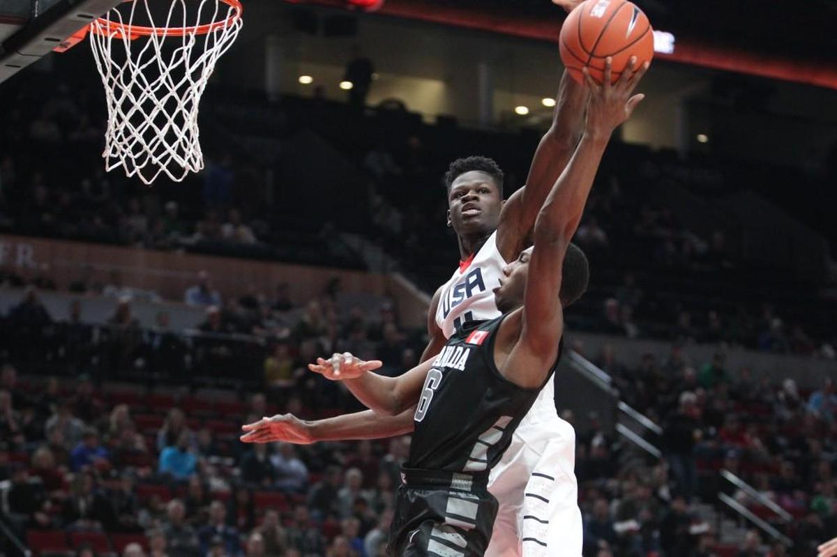 Mohamed Bamba, who’s still undecided, blocks a shot by World Select Team's R.J. Barrett in April.