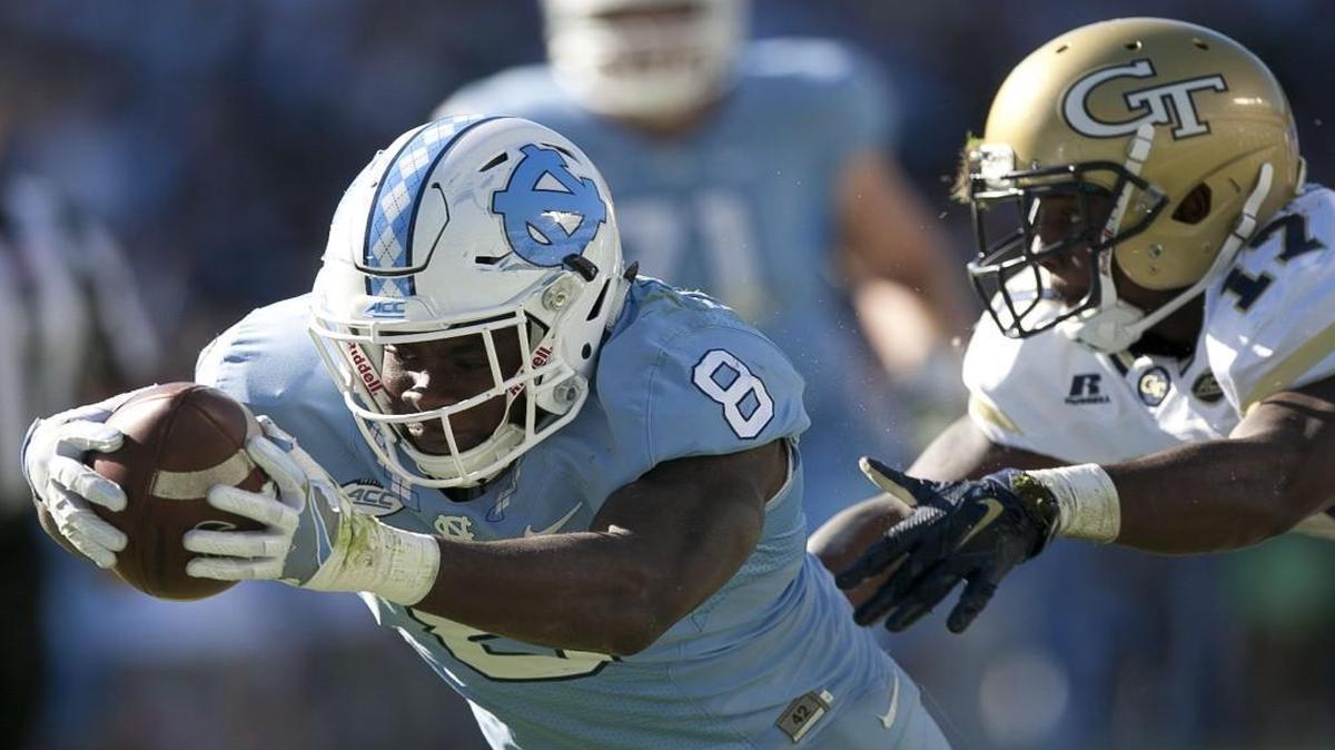 North Carolina’s T.J. Logan dives into the end zone on a 20-yard run for a touchdown ahead of Georgia Tech’s Lance Austin (17) to give the Tar Heels a 41-20 lead in the third quarter at Kenan Stadium.