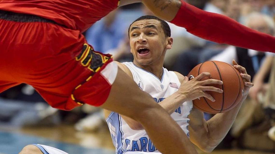 UNC's Marcus Paige (5) recovers a loose ball under Maryland's Nick Faust (5) in the final minutes of play. Paige score a game high 25 points leading the Tar Heels to a 75-63 victory on Tuesday February 4, 2014 at the Smith Center in Chapel Hill, N.C.