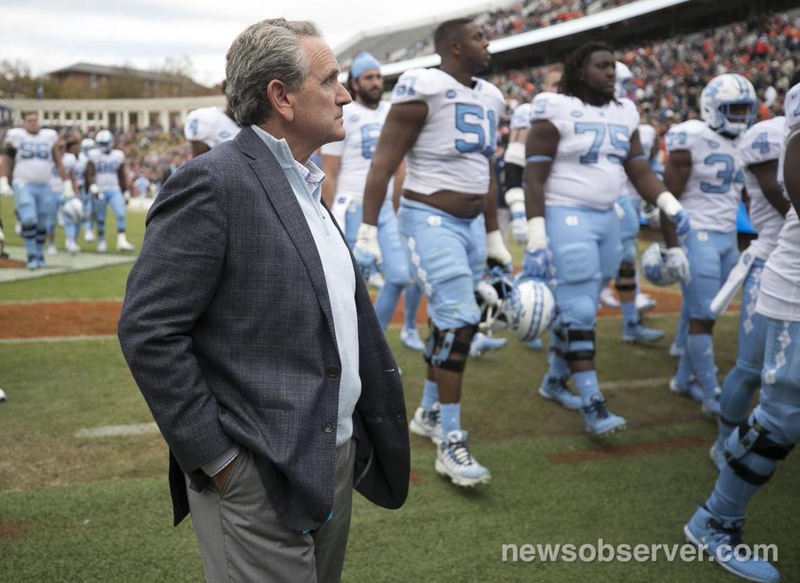 North Carolina athletic director Bubba Cunningham leaves the field with the football team following their 31-21 loss to Virginia on Saturday, October 27, 2018 at Scott Stadium in Charlottesville, Va.