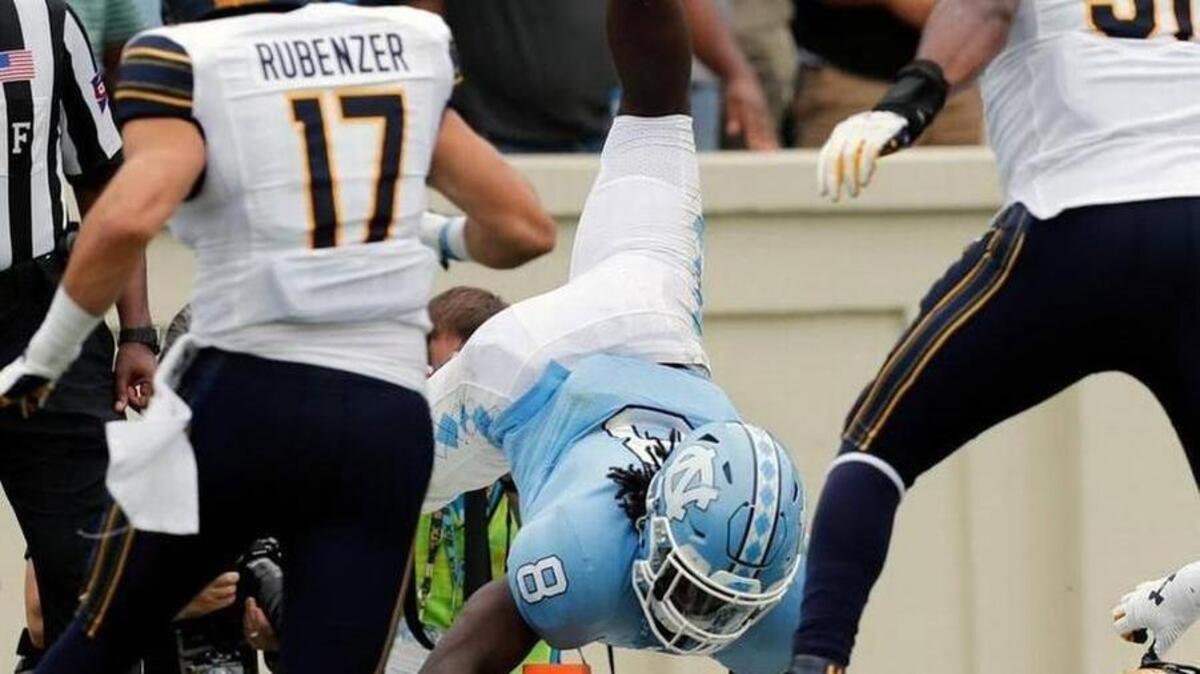 North Carolina’s Michael Carter (8) flips into the end zone in front of Cal’s Luke Rubenzer (17) and Raymond Davison (31) for a TD during the second quarter of an NCAA college football game played between the California Golden Bears and the UNC Tar Heels at Kenan Stadium in Chapel Hill, NC, on Sept. 2, 2017.