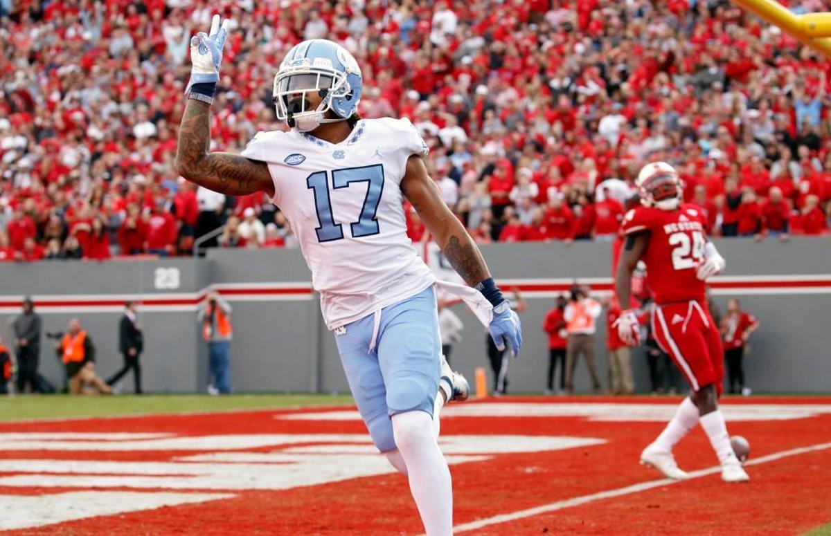 UNC's Anthony Ratliff-Williams (17) celebrates a TD in front of N.C. State's Nakia Robinson Jr. (24) during the first quarter.