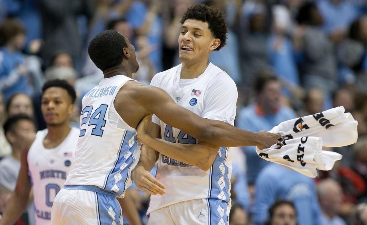 North Carolina’s Kenny Williams, left, gives Justin Jackson a hug after Jackson sank a 3-pointer during UNC’s 107-56 win over the Wolfpack on Jan. 8, 2017.
