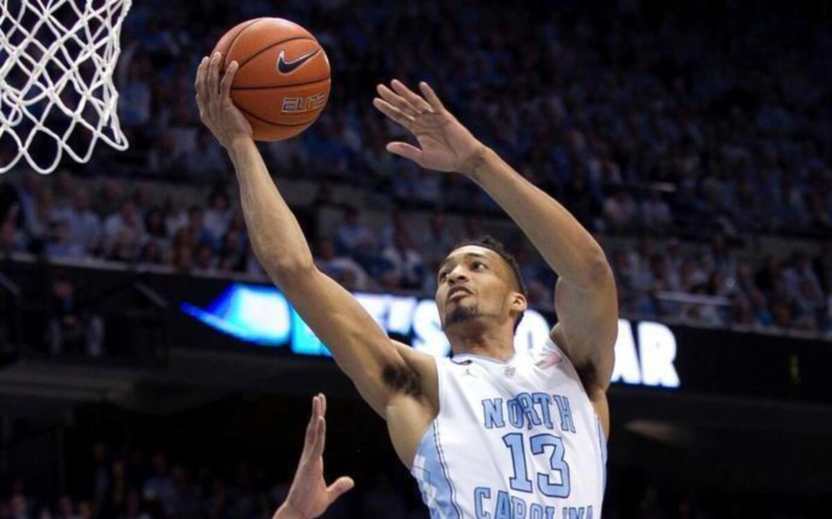 
North Carolina’s J.P. Tokoto (13) drives to the basket in front of Duke’s Jahlil Okafor (15) during their game Saturday, March 7, 2015 at the Smith Center in Chapel Hill.
