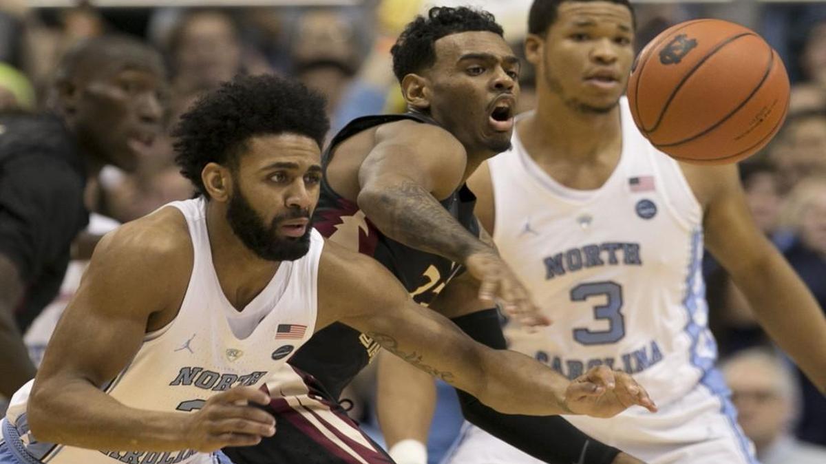 North Carolina’s Joel Berry II, left, forces a turnover by Florida State’s Xavier Rathan-Mayes during the first half at the Smith Center in Chapel Hill.