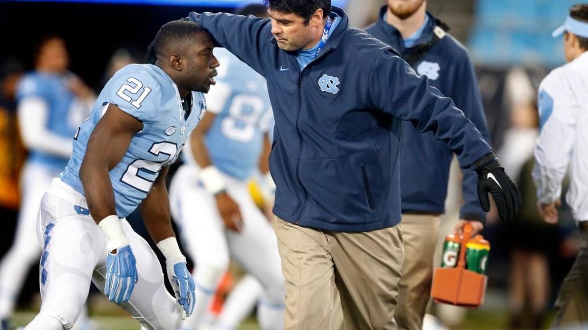 Seth Littrell, UNC’s offensive coordinator, talks with Romar Morris before UNC’s game against Clemson in the ACC Football Championship on Dec. 5. Littrell has taken the head coaching job at North Texas, leaving UNC coach Larry Fedora to fill the job with someone who won’t “step on any toes.”