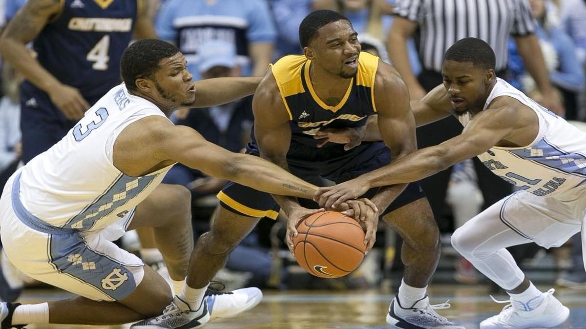 North Carolina’s Kennedy Meeks, left, and Seventh Woods and battle for a loose ball with Chattanooga’s Greg Pryor during the first half at the Smith Center in Chapel Hill.