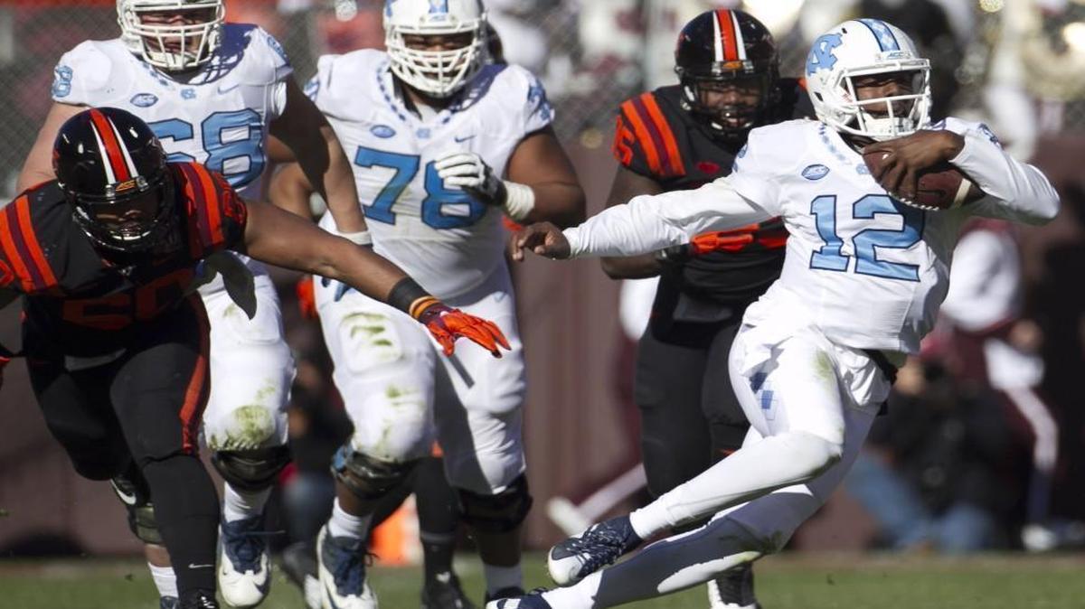 North Carolina quarterback Marquise Williams (12) looks for running room in the second quarter against Virginia Tech at Lane Stadium in Blacksburg, Va.