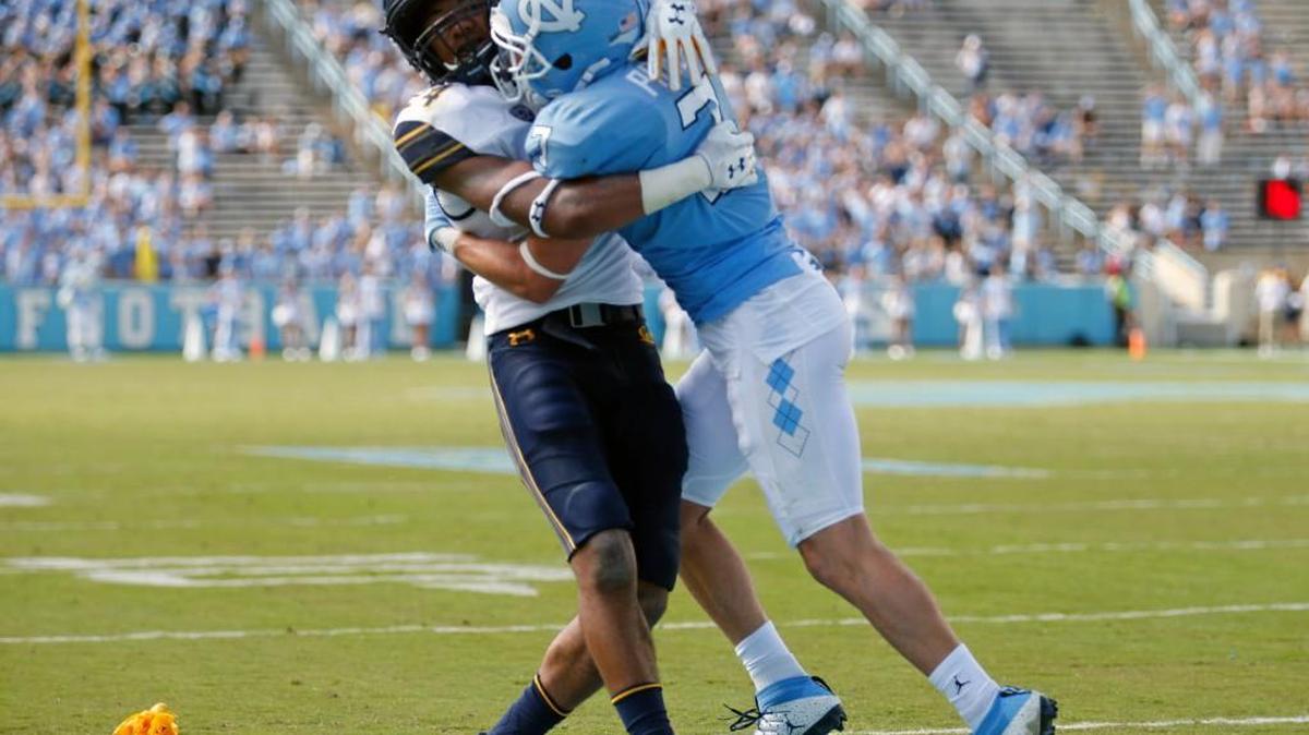 A flag is thrown as UNC's Austin Proehl (7) get into a scuffle with Cal's Camryn Bynum (24) near the end of the fourth quarter.