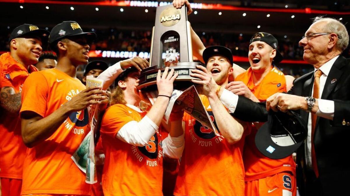 The Syracuse Orange celebrate their 68 to 62 win over the Virginia Cavaliers with teammates during the 2016 NCAA Men's Basketball Tournament Midwest Regional Final at United Center on March 27, 2016 in Chicago, Illinois. (Photo by Jamie Squire/Getty Images)