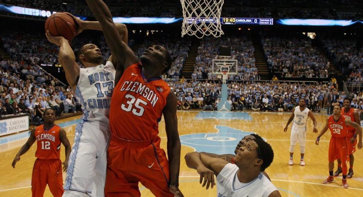 North Carolina’s J.P. Tokoto shoots over Clemson’s Landry Nnoko in Chapel Hill in 2014.