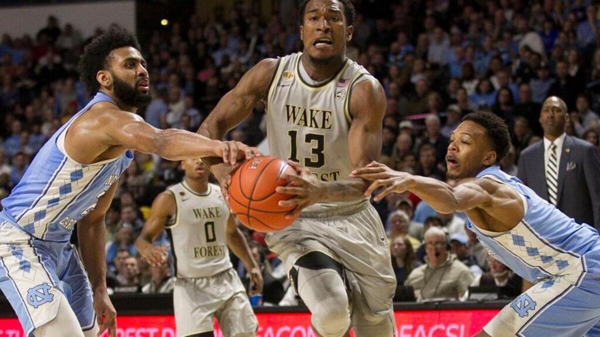 North Carolina’s Joel Berry II (2) and Nate Britt (0) defend Wake Forest’s Bryant Crawford (13) on Jan. 11.