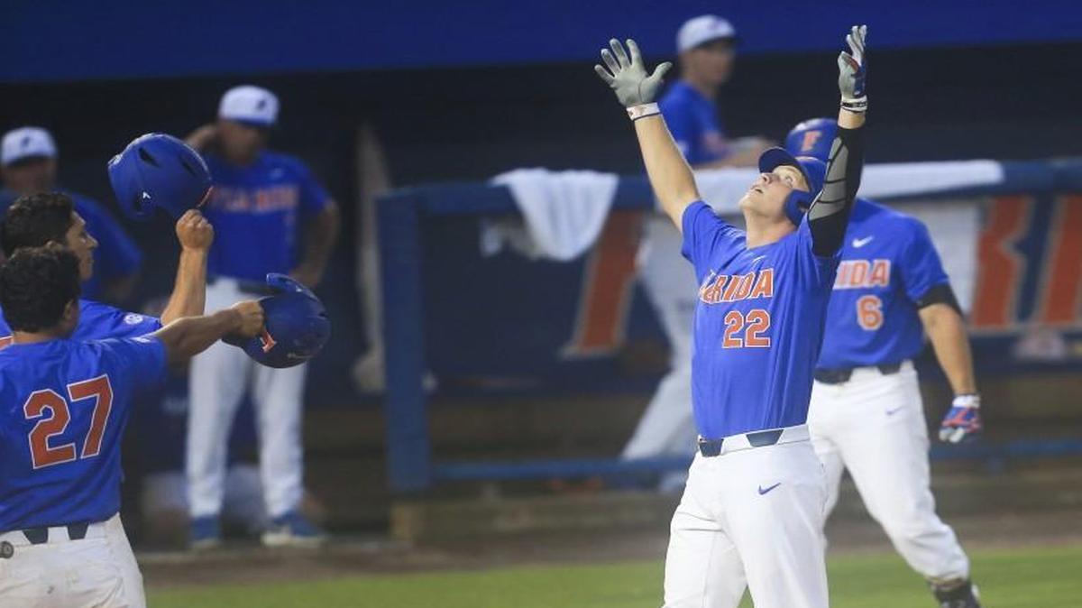 Florida batter JJ Schwarz (22) celebrates at home plate after hitting a two-run home run in the third inning against Wake Forest on Monday, June 12, 2017, in Gainesville, Fla.