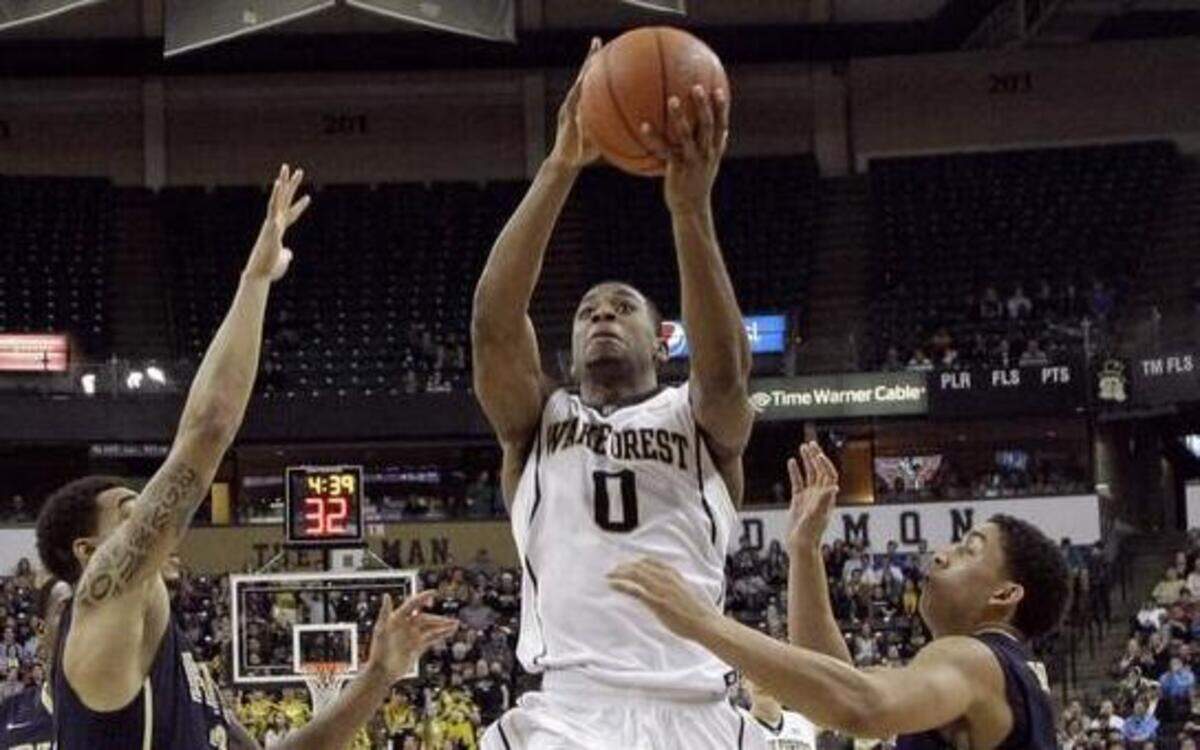 
Wake Forest’s Codi Miller-McIntyre, center, drives between Pittsburgh’s James Robinson, right, and Cameron Wright Sunday night in Winston-Salem.
