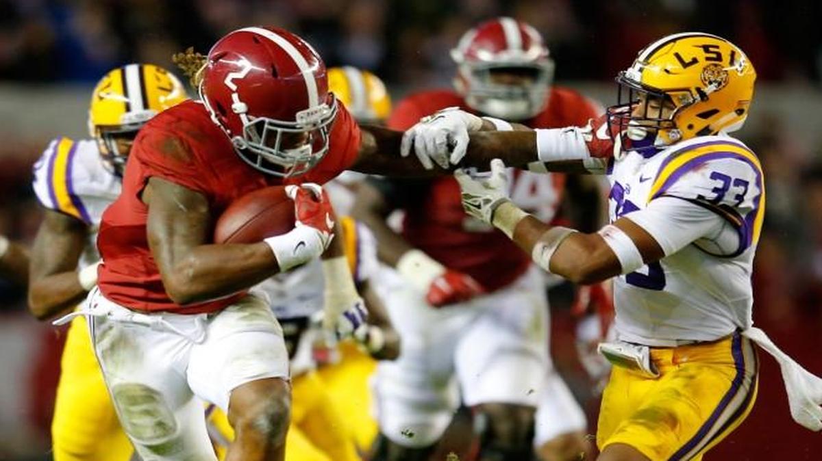 Derrick Henry of the Alabama Crimson Tide rushes away from Louisiana State’s Jamal Adams (33) in the second quarter at Bryant-Denny Stadium on Saturday in Tuscaloosa, Ala.