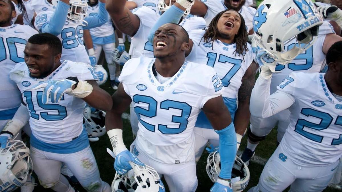 North Carolina’s Cayson Collins (23) and his teammates celebrate their 30-27 overtime victory over Virginia Tech on Saturday at Lane Stadium in Blacksburg, Va.
