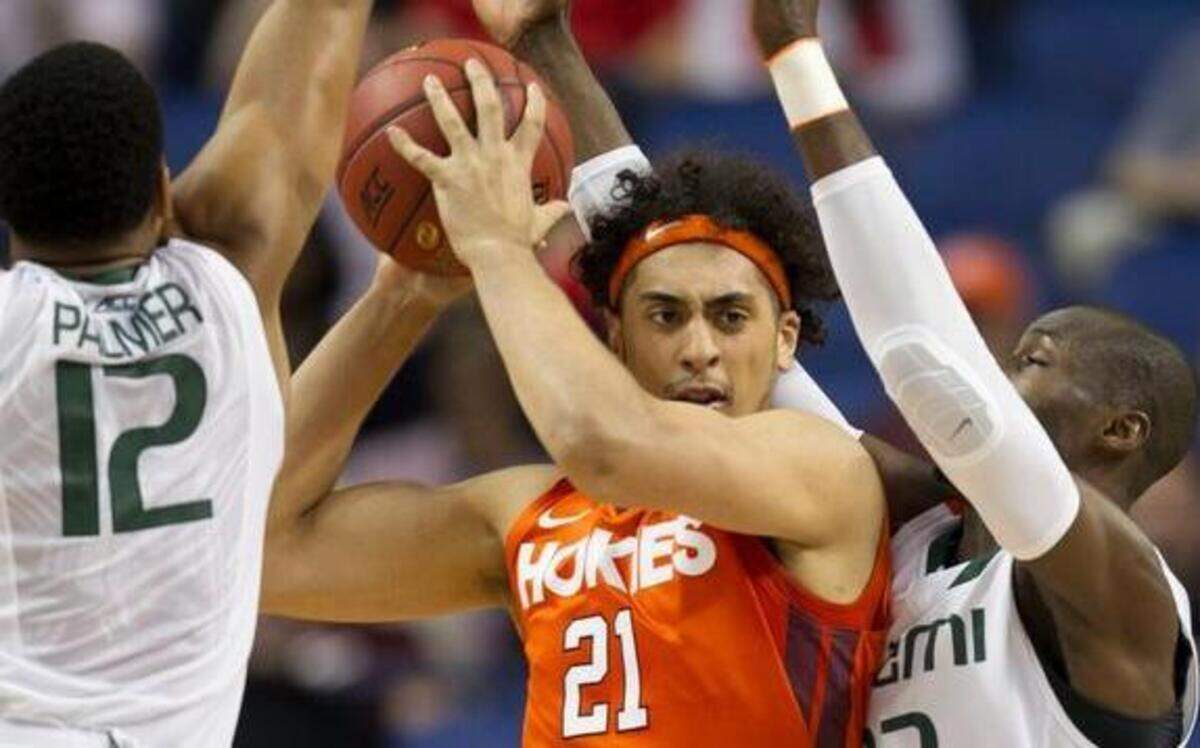 
Sathcel Pierce (21) of Virginia Tech is surrounded by Hurricanes’ James Palmer (12) and Tonye Jekiri during the first half of their ACC Tournament game. Miami won 59-49.  Check nando.com/acc for game story and photos.



