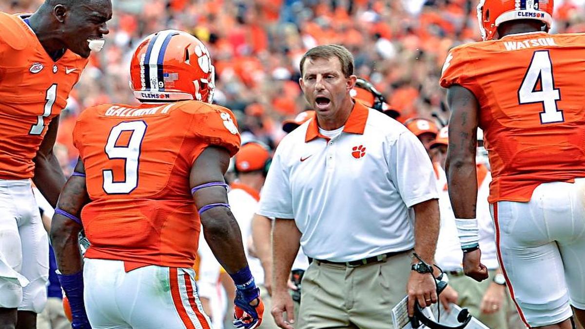 
Clemson head coach Dabo Swinney, along with Deshaun Watson, right, and Jayron Kearse celebrate Charone Peake's touchdown during the second half of an NCAA college football game against Appalachian State Saturday, Sept. 12, 2015, in Clemson, S.C. Clemson won 41-10. 
