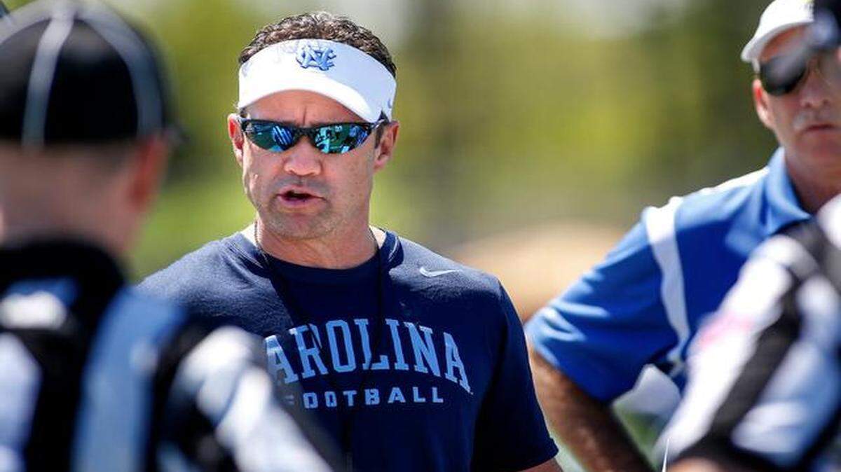 
North Carolina coach Larry Fedora talks to officials on the sidelines before the start of the Tar Heels' final spring football scrimmage, at Rocky River High School in Mint Hill Saturday, April 11, 2015. (Nell Redmond photo)
