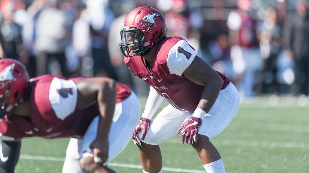 N.C. Central senior linebacker De’Niro Laster, right, sports his lucky gold mouthpiece last weekend against Gardner-Webb.