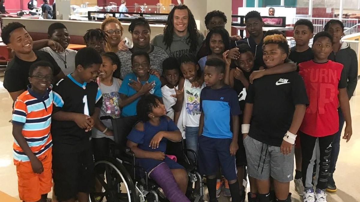 N.C Central wide receiver Jacen Murphy, back middle, poses with some young football fans on campus last week.