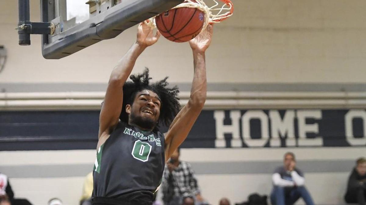 Coby White (0) of Greenfield dunks for 2 points. The Greenfield School Knights played the Garner Trojans in the Millbrook Showcase high school boys basketball event on Dec. 2, 2017.