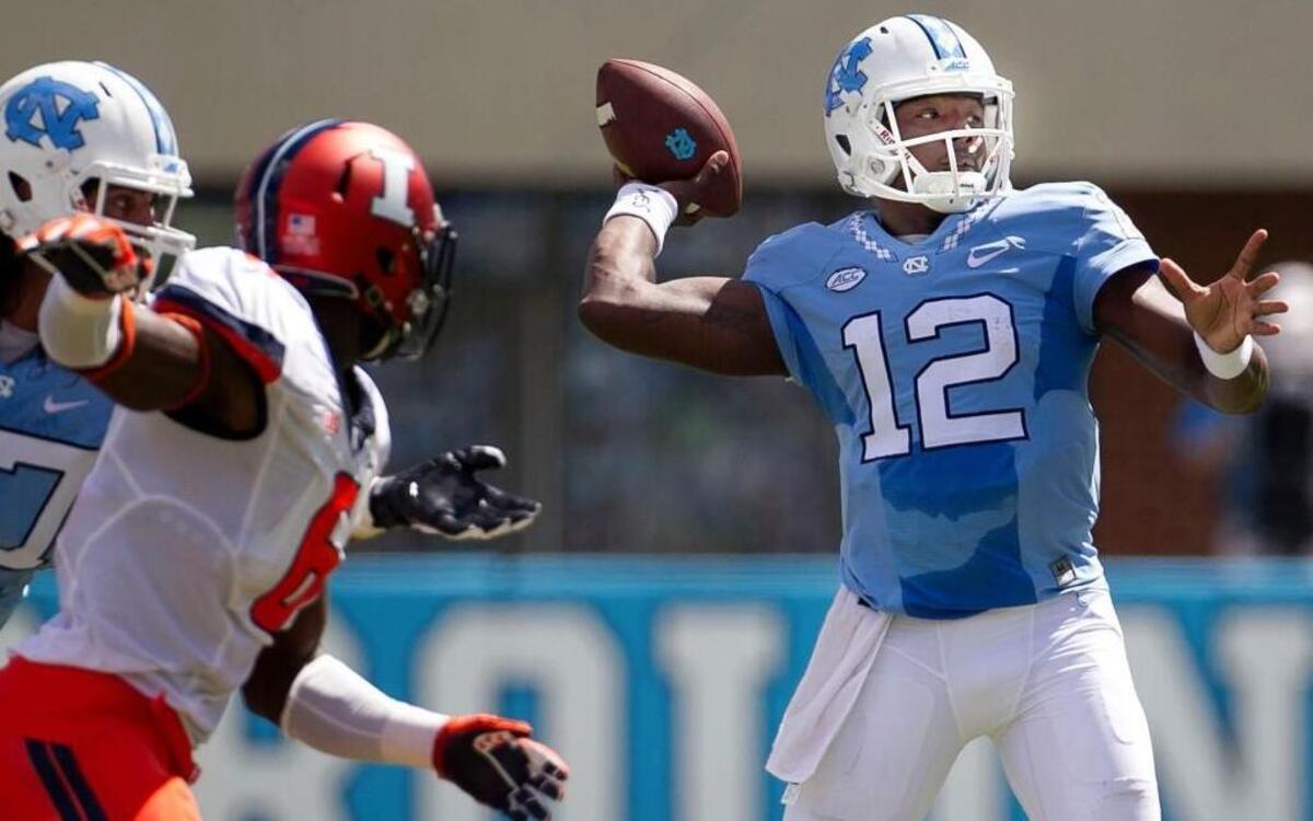 
North Carolina quarterback Marquise Williams (12) looks for Elijah Hood, connecting for a seven-yard gain in the first quarter against Illinois at Kenan Stadium in Chapel Hill.  
