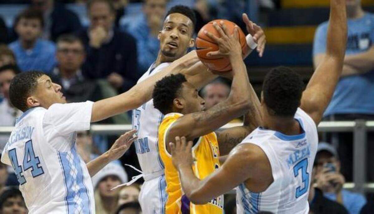
East Carolina's B.J. Tyson drives to the basket through the UNC defenders Justin Jackson, left, J.P. Tokoto, center, and Kennedy Meeks during the Pirates game on Dec. 7 at the Smith Center in Chapel Hill. Tyson was announced as a unanimous selection to the the American Athletic Conference’s all-rookie team Tuesday.
