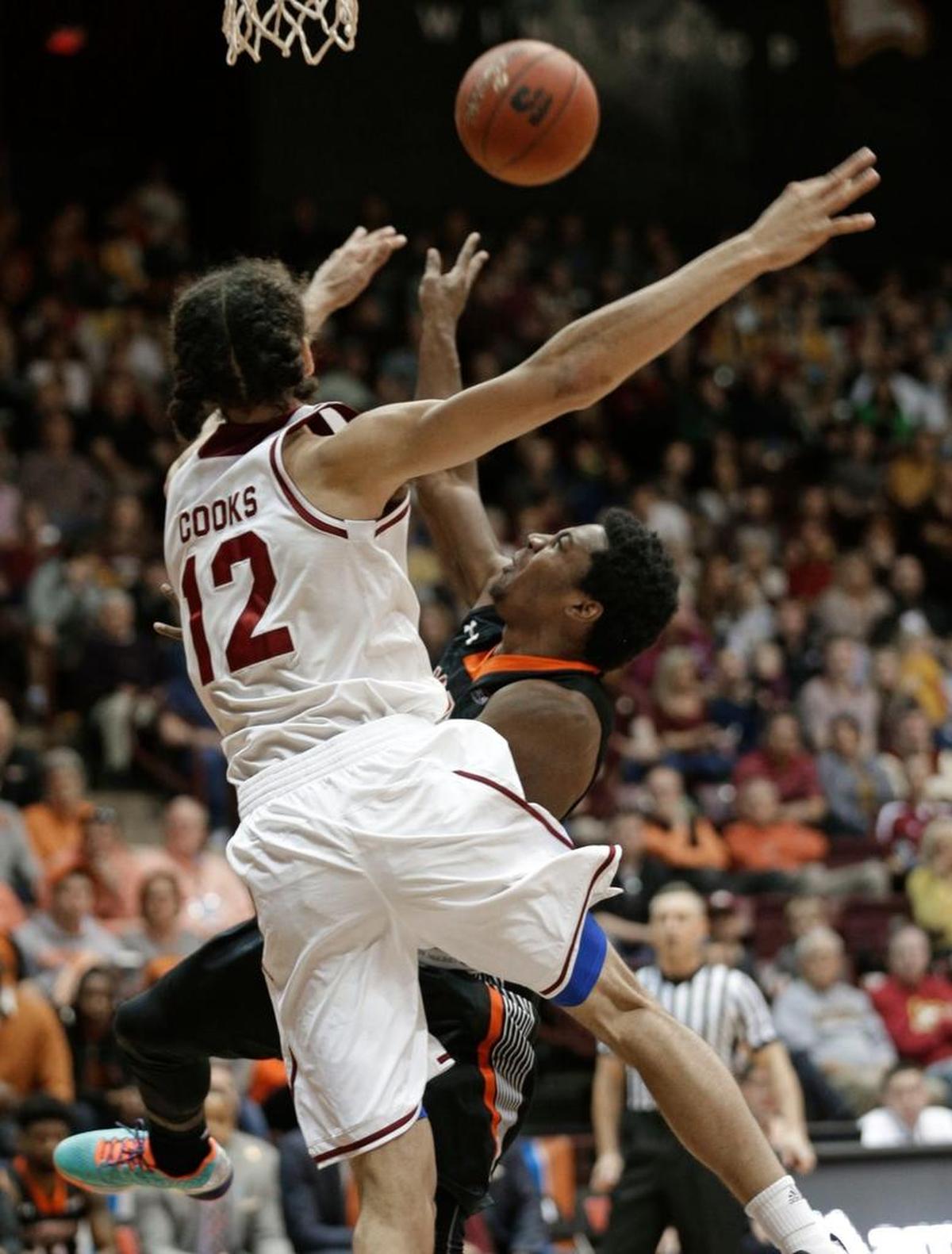 Campbell’s Chris Clemons, right, shoots against Winthrop’s Xavier Cooks in the Big South tournament title game on March 5. 2017. Winthrop won 76-59.