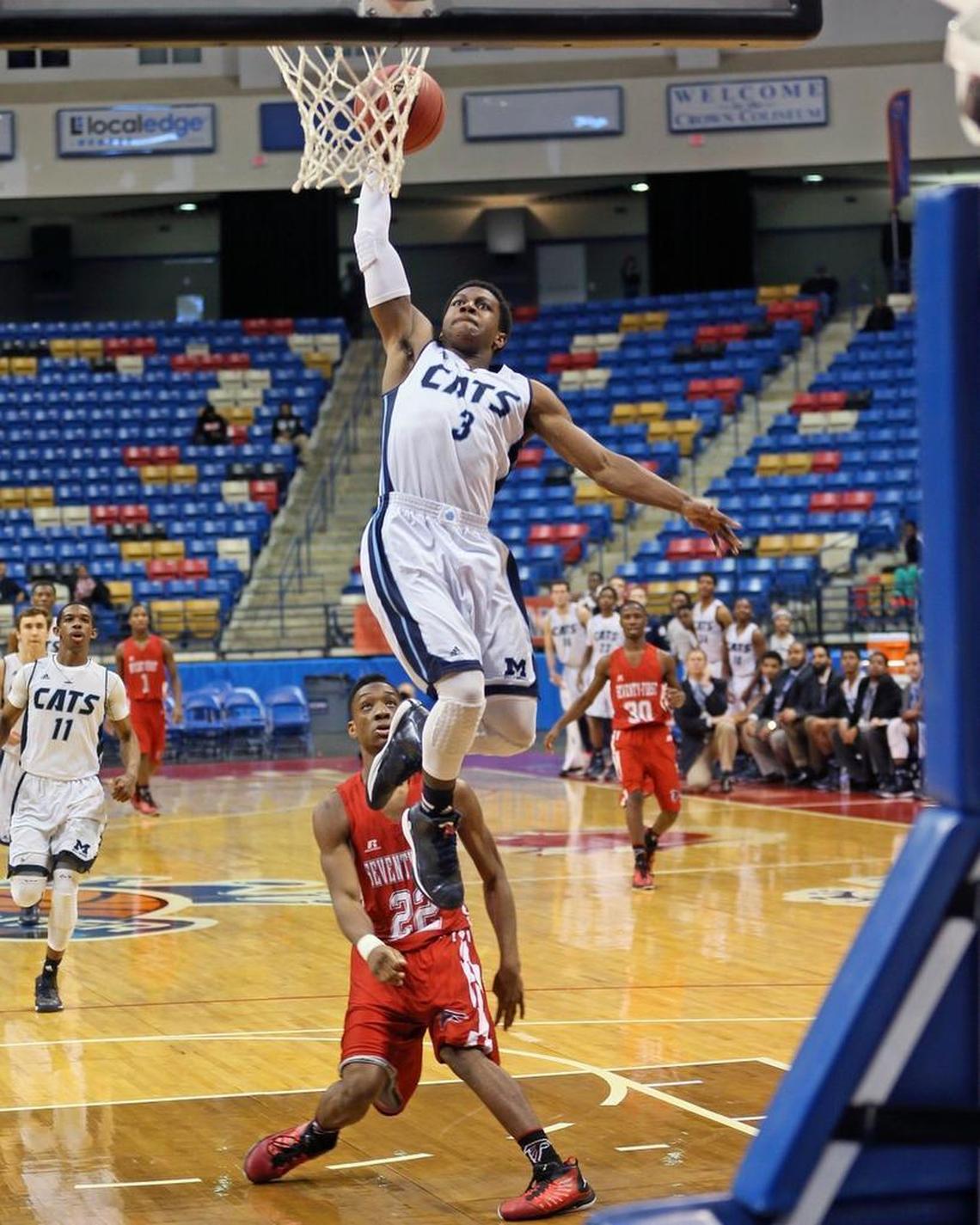 Chris Clemons (3) breaks down the lane for a dunk for Milbrook as Seventy-First's Joshua Bryant (22) watches the play.