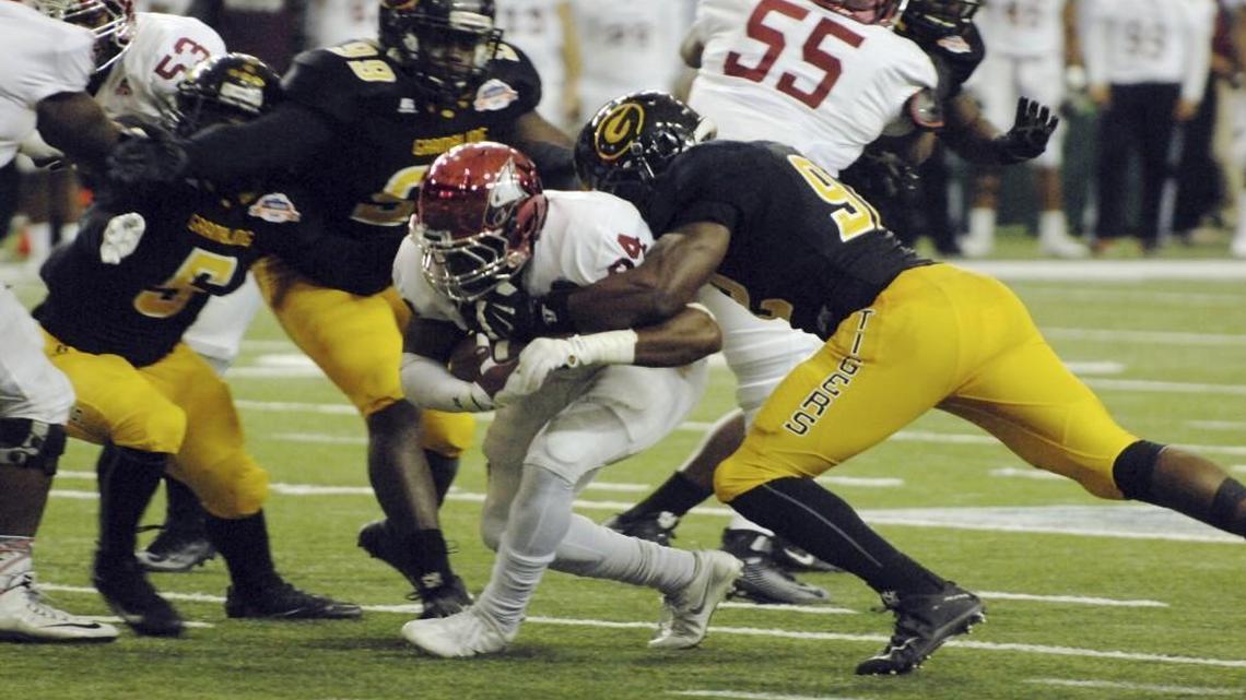 North Carolina Central running back Dorrel McClain is surrounded on the tackle by Grambling State defenders during the first half of the Celebration Bowl College football game at the Georgia Dome in Atlanta.