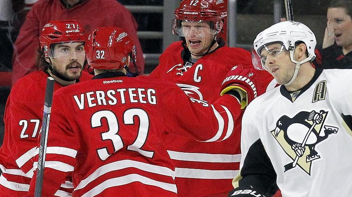 The Carolina Hurricanes' Eric Staal (12) celebrates his goal with Justin Faulk (27) and Kris Versteeg (32) while the Pittsburgh Penguins' Chris Kunitz (14) skates away during the second period.