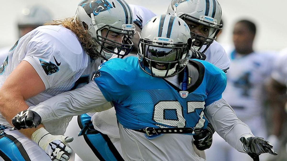 
Carolina Panthers defensive end Mario Addison, center, spins away from guard Andrew Norwell, left, and tackle Michael Oher, back right, during practice on Wednesday, Aug. 5, 2015, at Wofford College in Spartanburg, S.C. 
