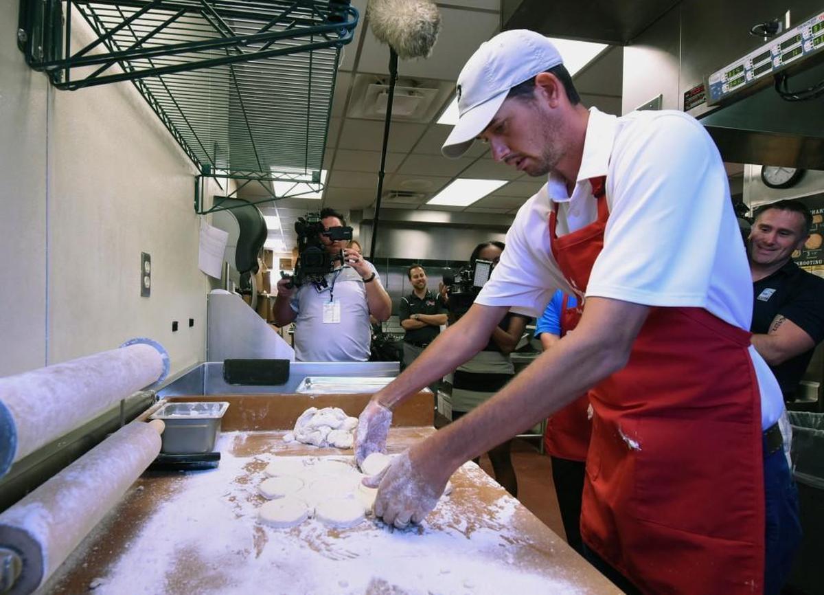 Golfer Chesson Hadley makes biscuits in the kitchen at a Bojangles in Wilmington on May 3. Hadley was in town for the Wells Fargo Championship.