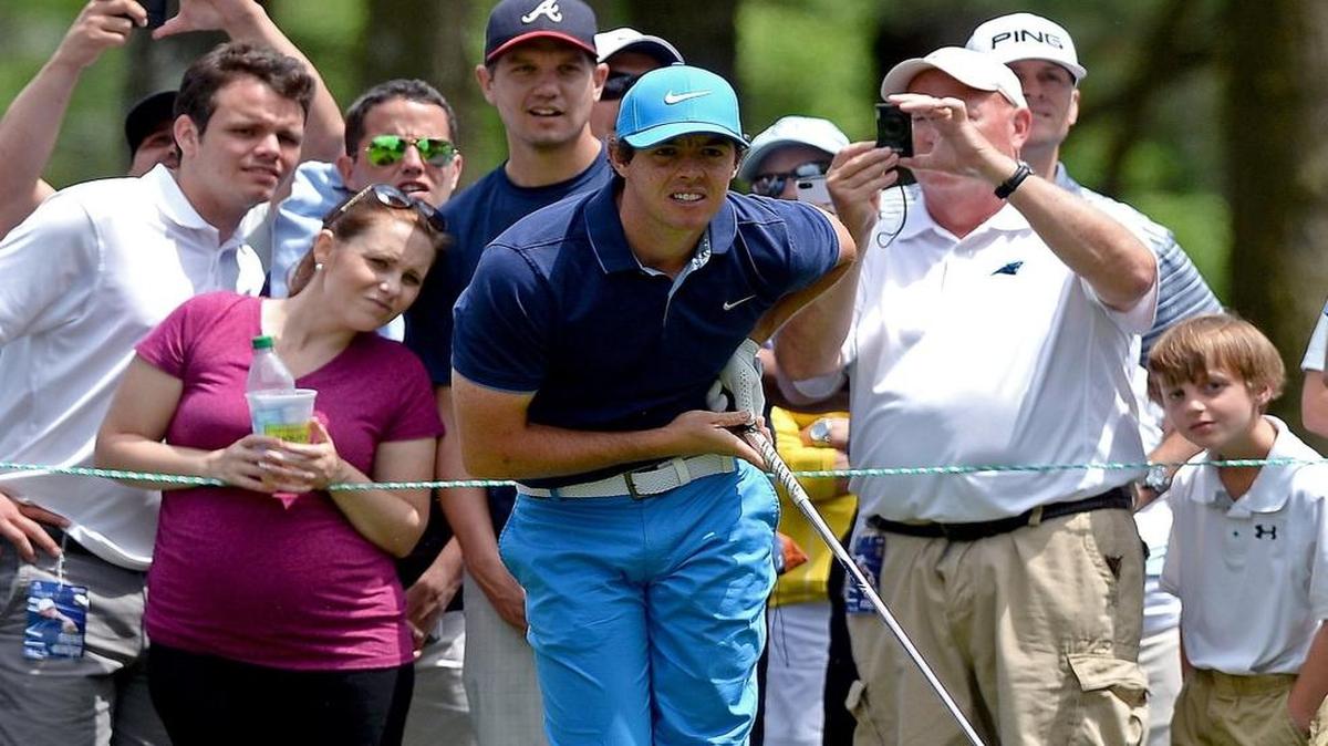 Two-time champion Rory McIlroy watches his drive from the sixth tee with members of the gallery during Wednesday’s pro-am at Quail Hollow Club in Charlotte.