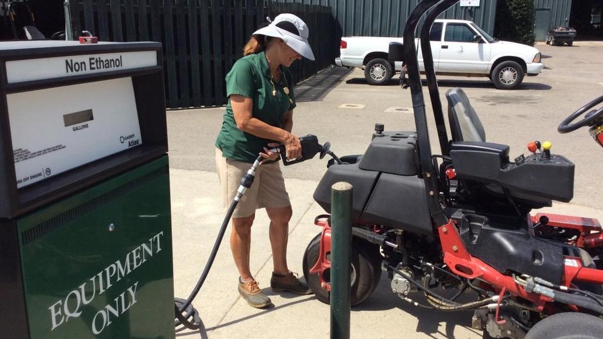 Kaye Pierson fills a mower with gas earlier this month. Pierson completed a golf Grand Slam after mowing the grass at the PGA Championship on Monday.
