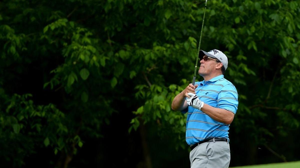Carolina Panthers coach Ron Rivera watches the flight of his shot to the eighth green during Monday’s Pro-Am at Quail Hollow Club.