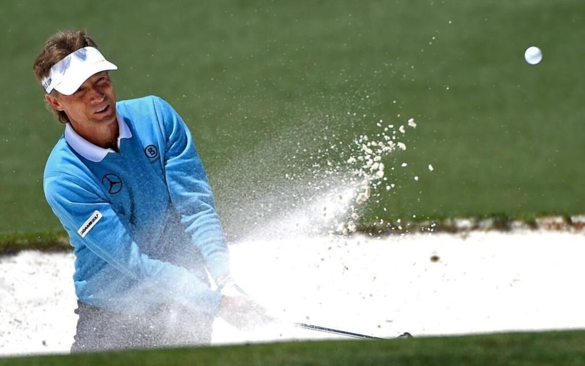 Bernhard Langer hits his ball from a sand trap along the second green during third round action in The Masters on Saturday at Augusta National Golf Club. Langer finished the round at -1.