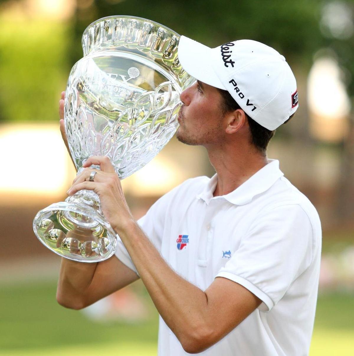 Raleigh native Chesson Hadley kisses his hardware after winning the Rex Hospital Open in 2013 at Wakefield Plantation.