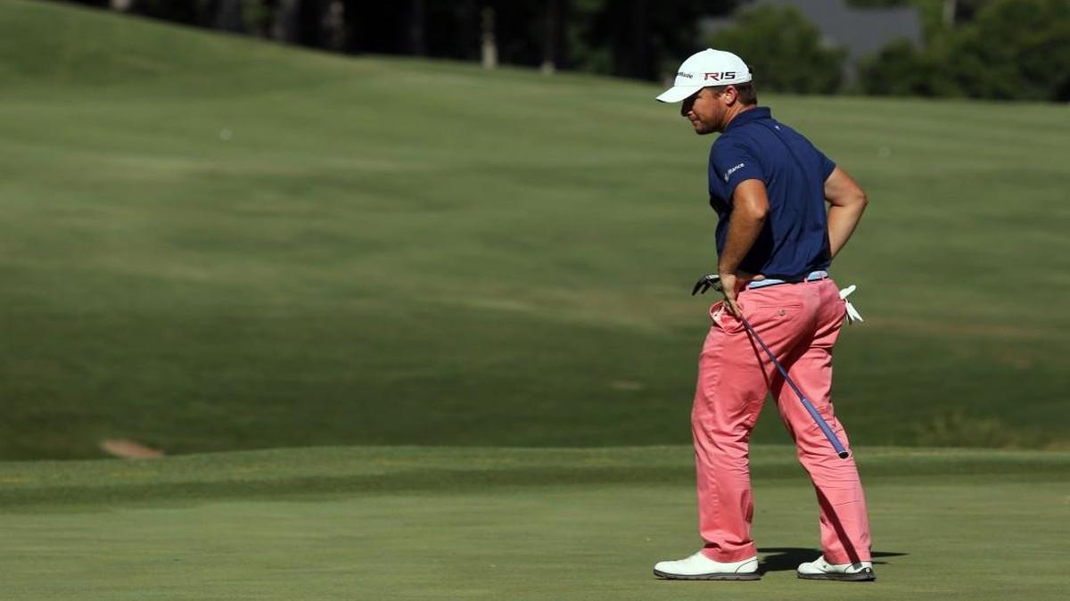 Kyle Thompson looks down at the hole after his putt does not make it into the 18th hole during the Rex Hospital Open, part of the Web.com Tour, at the TPC Wakefield Plantation golf course in Raleigh on May 31, 2015.