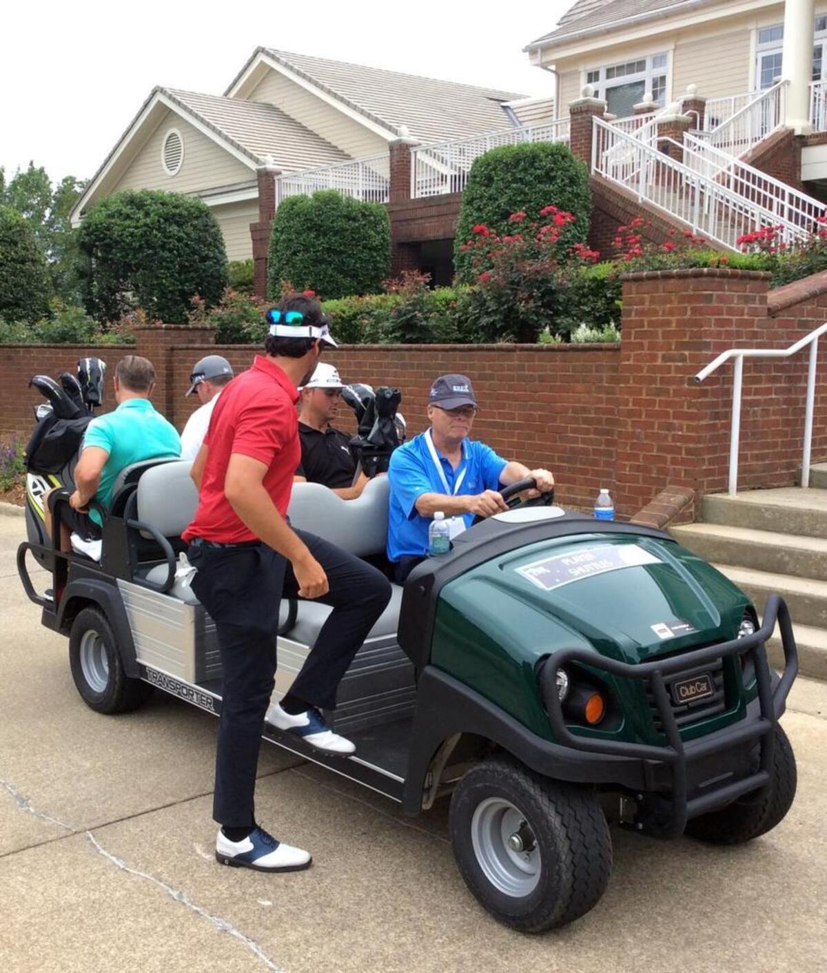 Rex Hospital Open volunteer Kurt Ruesch, in blue, shuttles players and caddies to the TPC Wakefield Plantation clubhouse on May 30, 2017.