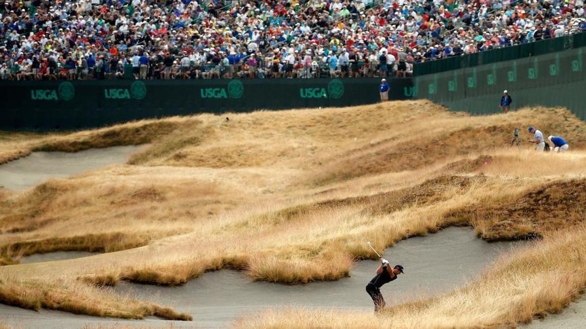 
 Dustin Johnson of the United States hits his second shot on the 18th hole during the first round of the 115th U.S. Open Championship at Chambers Bay on June 18, 2015 in University Place, Washington. 
