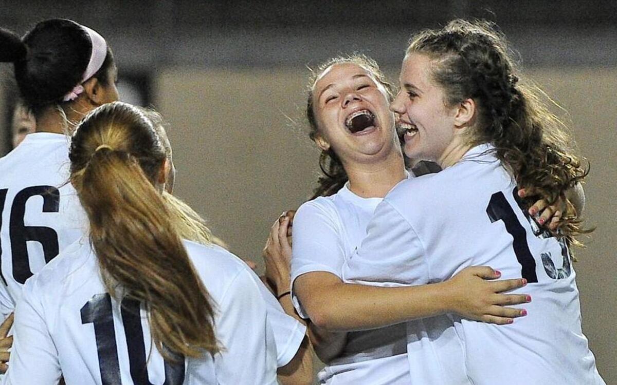 Teammates celebrate with Northern Durham’s Maddie Whittaker (5) after they defeated Riverside 2-1 in the Bull City Cup finals at Durham County Stadium in Durham on April 29, 2016.