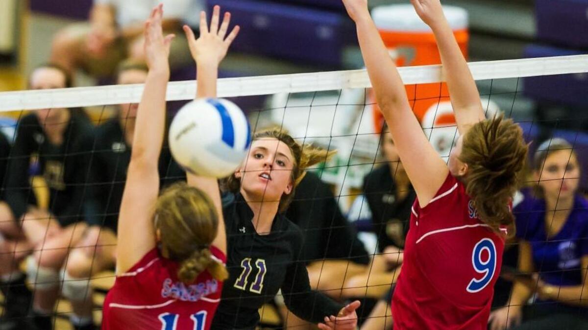 
Broughton's Katja Ehlers (11) spikes the ball between Sanderson's Krissy Thompson (11) and Parker Moody (9) during a volleyball on Thursday, September 24, 2015 in Raleigh, N.C. Broughton Capitals won 3-0.
