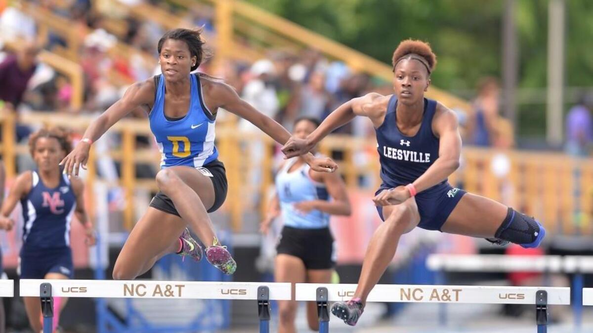 Shellbi Chapman, right, of Leesville Road comes in first, followed closely by Jazmine Gooden, left, of Dudley in the Girls 300 Meter Hurdles 4A Finals during the NCHSAA 4A Track and Field Championships that took place at the North Carolina A&T State University in Greensboro, N.C. on Saturday, May 21, 2016.