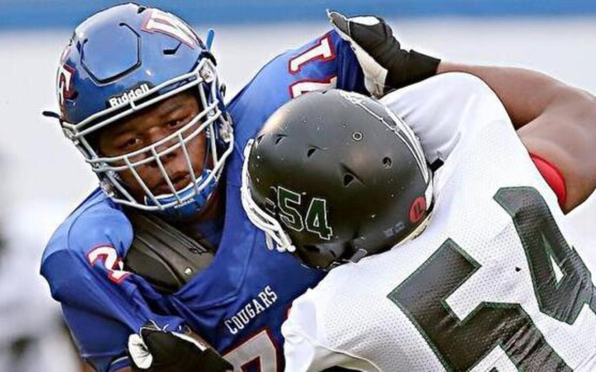 Wake Forest's Dexter Lawrence II (71) fights off Southeast's Donte Wooten (54) during the Southeast high school football game with Wake Forest high school in Wake Forest, N.C., September 9,2015. Wake forest leads at the half 38-0.