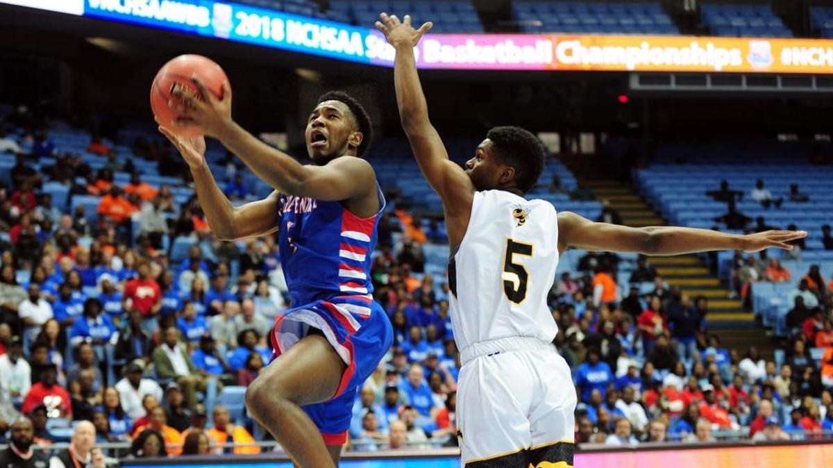 Forest Hills' Trey Belin (5) defends a shot by Greene Central's Torrence Clark (left). The Greene Central Rams and the Forest Hills Yellow Jackets played the boys NCHSAA 2A basketball championship game in Chapel Hill on Saturday, March 10, 2018.