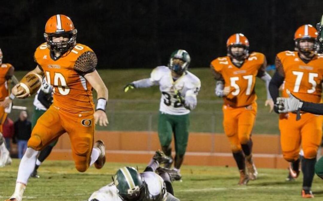 Orange’s Bryse Wilson breaks one tackle on and looks to take on his next defender, Northwoood’s Jaquan Headen (17). The Northwood Chargers and Orange Panthers football game was played in Hillsborough, N.C. on Friday, November 13, 2015. Orange won 20-0.
