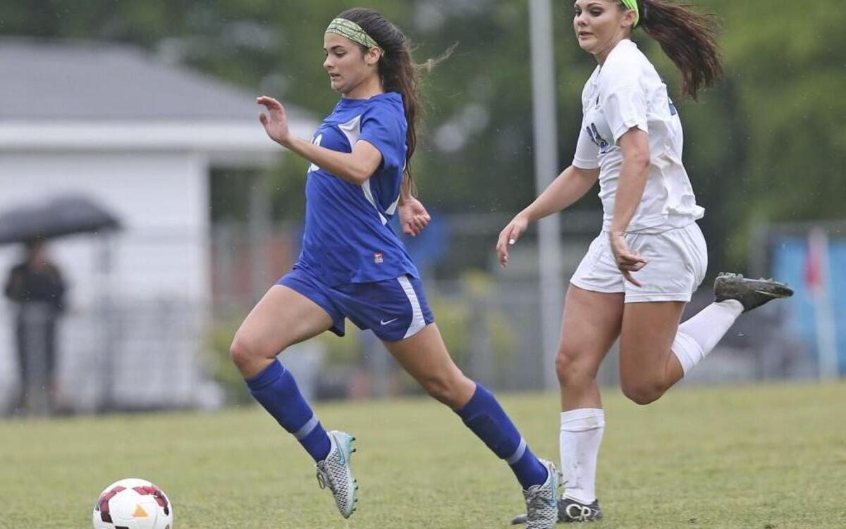 Athens Drive’s Rachel Snyder (19) breaks away from Clayton defender Nicole Guerrero (23) on a run down the field. Coverage from the 4A NCHSAA soccer playoff game between the Clayton High Comets and Athens Drive High Jaguars played in Clayton, N.C. on Tuesday, May 17, 2016. Athens Drive defeated Clayton 3-1 in OT.
